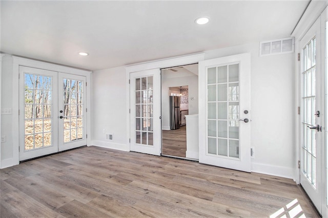 201 Templar Ave, Pinckney, MI 48169 - interior space with plenty of natural light, french doors, wood finished floors, and visible vents