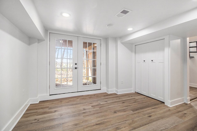 201 Templar Ave, Pinckney, MI 48169 - unfurnished dining area with visible vents, baseboards, wood finished floors, and french doors