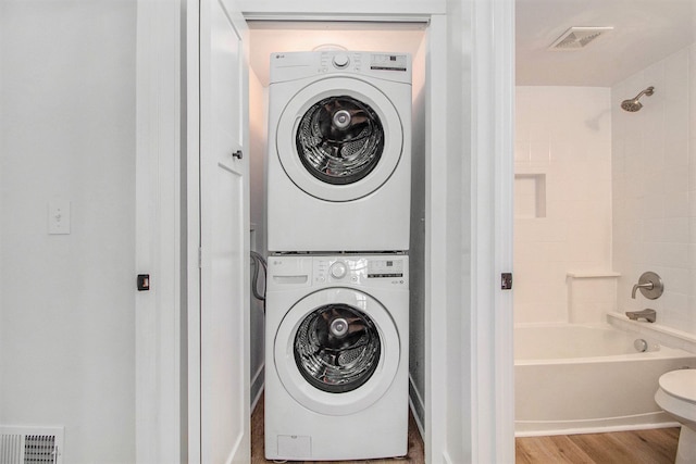 201 Templar Ave, Pinckney, MI 48169 - washroom featuring laundry area, visible vents, wood finished floors, and stacked washer and clothes dryer