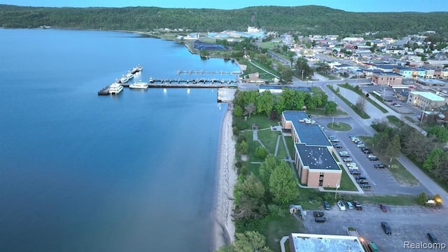drone / aerial view featuring a forest view and a water view