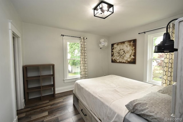 bedroom featuring baseboards and dark wood-style floors
