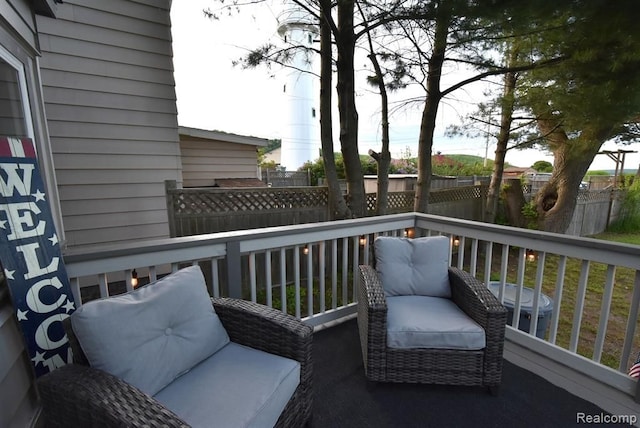 wooden terrace featuring central AC unit and fence
