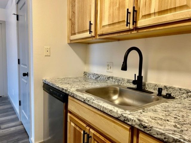 8741 Green Willow St Unit 11, Brighton, MI 48116 - kitchen with stainless steel dishwasher, a sink, dark wood-style flooring, and light stone countertops