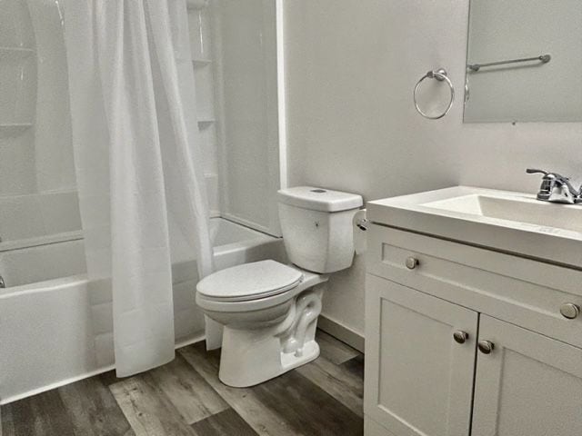8741 Green Willow St Unit 11, Brighton, MI 48116 - full bathroom with shower / bath combination with curtain, toilet, wood finished floors, and vanity