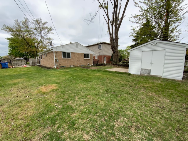 view of yard featuring an outbuilding, a shed, and fence