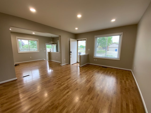 unfurnished room featuring visible vents, wood finished floors, baseboards, and recessed lighting