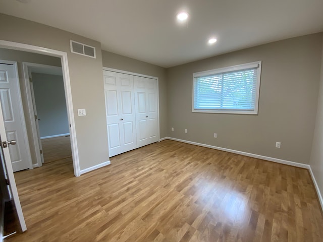 unfurnished bedroom featuring baseboards, recessed lighting, light wood-style floors, and visible vents