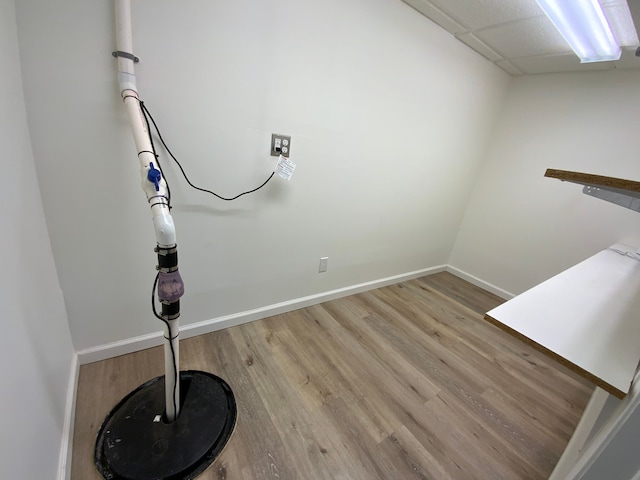 laundry room featuring baseboards and light wood-type flooring
