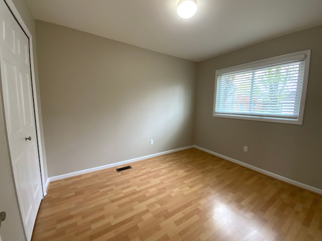 interior space with baseboards, a closet, light wood finished floors, and visible vents