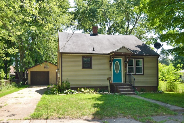 bungalow-style home featuring an outbuilding, fence, a garage, and driveway