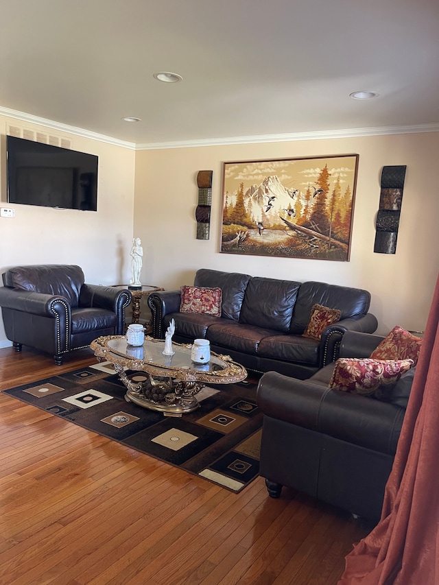 living area featuring wood-type flooring, ornamental molding, and recessed lighting