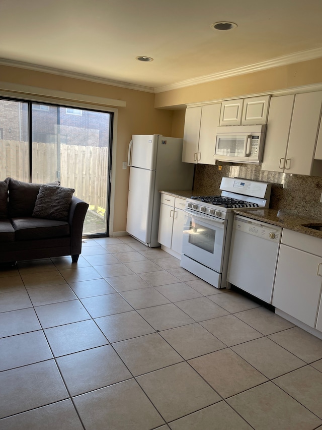 kitchen with backsplash, white cabinetry, white appliances, crown molding, and light tile patterned floors