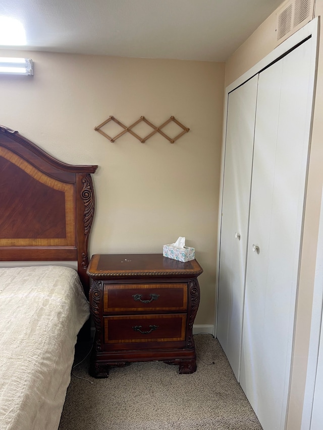 bedroom featuring a closet, visible vents, and carpet