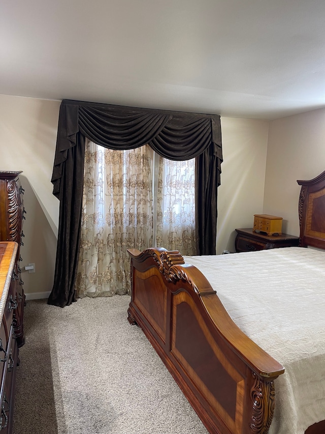 bedroom featuring baseboards and carpet flooring