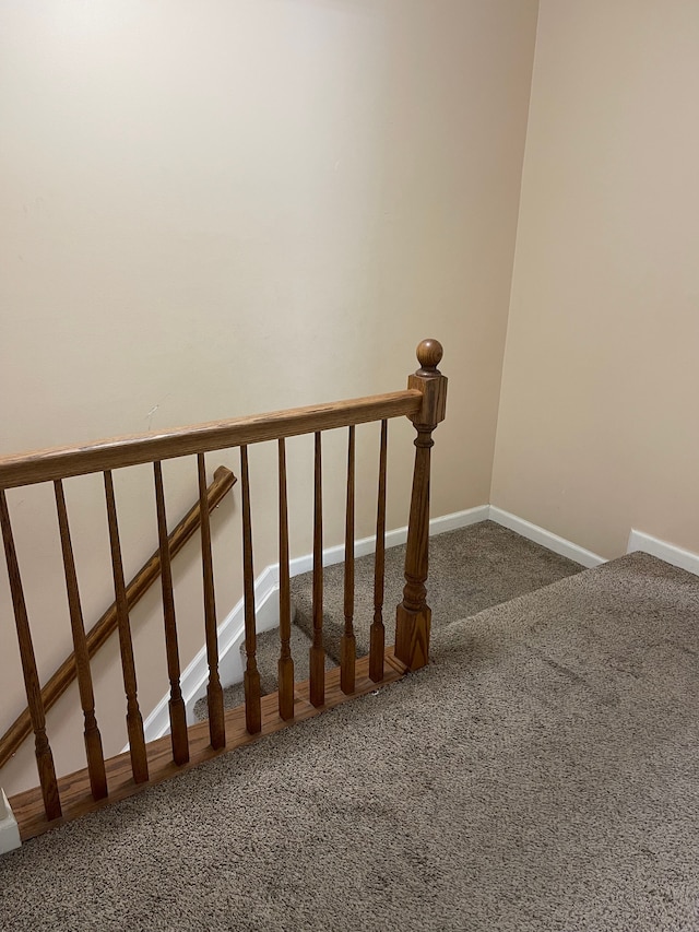 stairs featuring baseboards and carpet