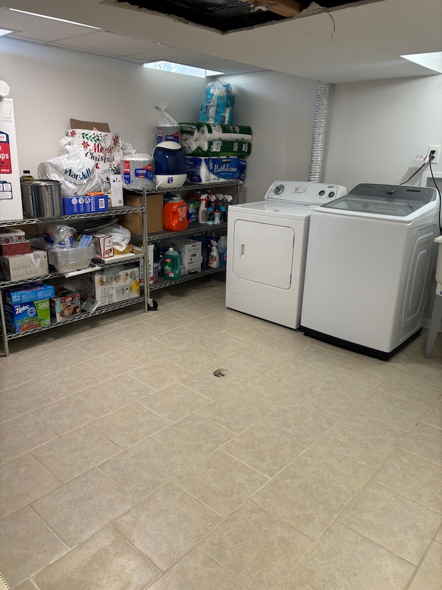washroom with independent washer and dryer, laundry area, and light tile patterned floors