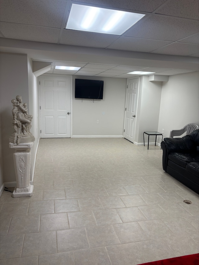finished below grade area featuring baseboards and a drop ceiling