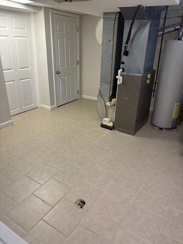 finished below grade area featuring water heater, tile patterned flooring, heating unit, and baseboards