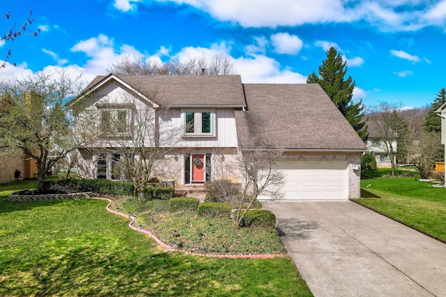 traditional home featuring an attached garage, a shingled roof, a front yard, and concrete driveway