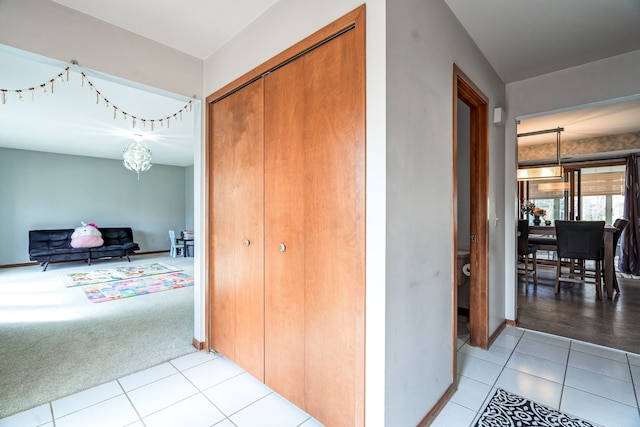 corridor featuring carpet floors and tile patterned flooring
