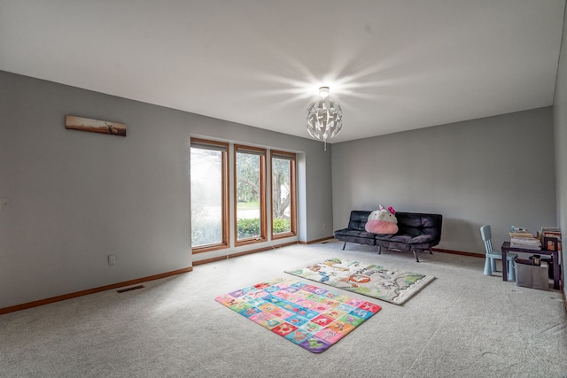 rec room featuring baseboards, a notable chandelier, carpet flooring, and visible vents