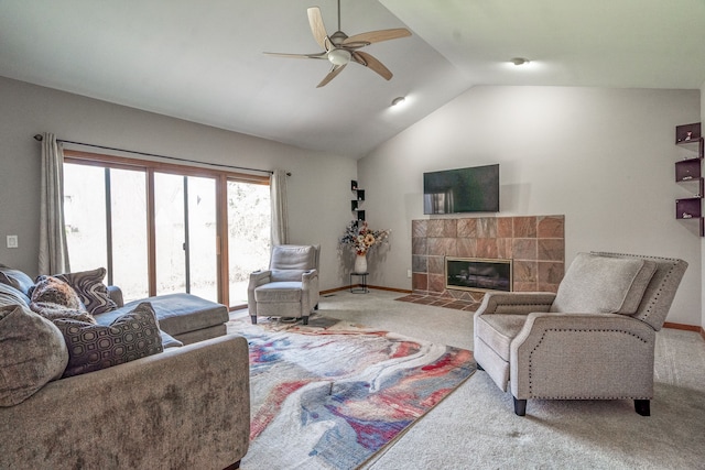 living room featuring a fireplace, lofted ceiling, a ceiling fan, and carpet