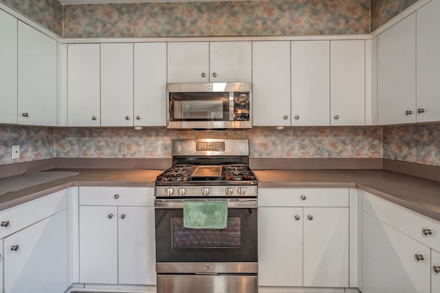 kitchen with appliances with stainless steel finishes and white cabinetry