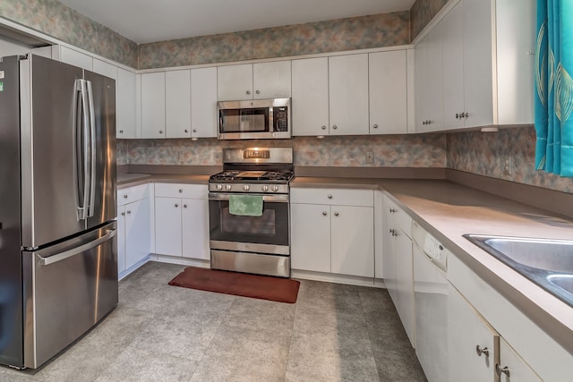 kitchen with white cabinets, stainless steel appliances, and a sink