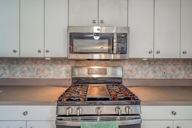kitchen featuring backsplash, white cabinetry, and stainless steel appliances