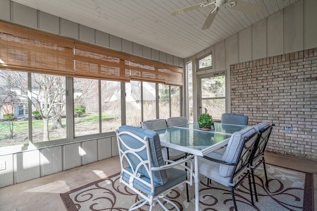 sunroom / solarium with outdoor dining space and ceiling fan