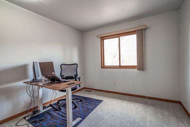 carpeted office featuring baseboards