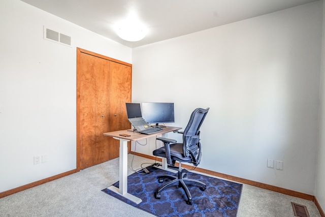 office space with baseboards, visible vents, and carpet floors