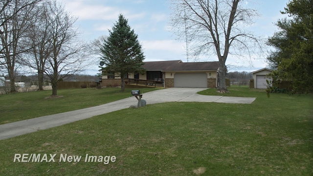 single story home with a garage, a front yard, brick siding, and driveway