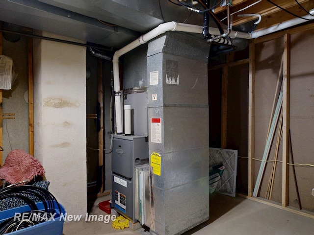 utility room featuring heating unit