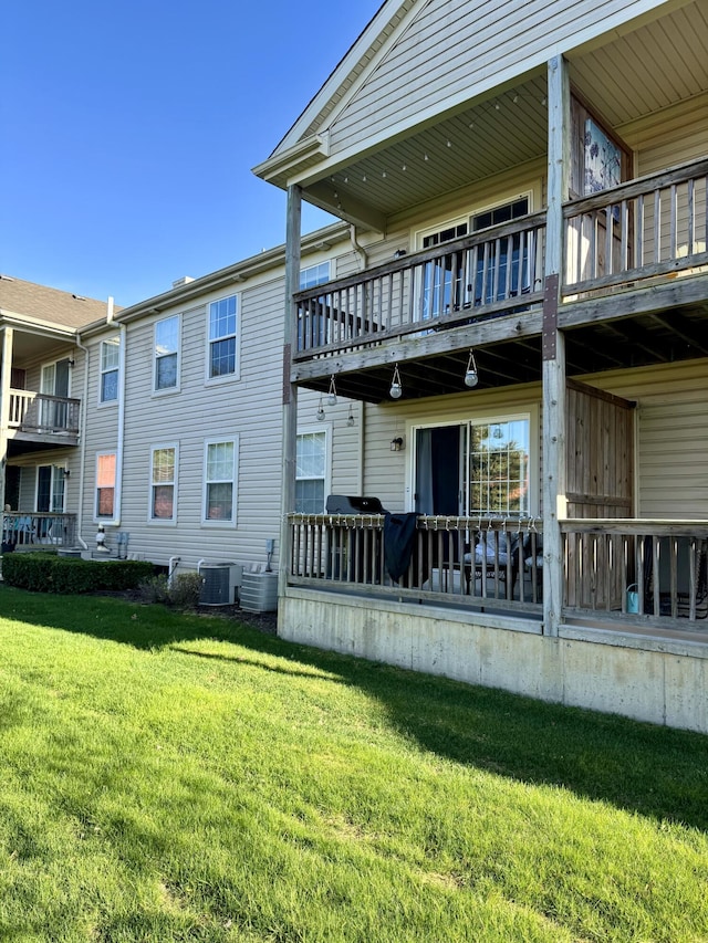 295 Victoria Dr, Dexter, MI 48130 - back of house with a yard, cooling unit, and a balcony