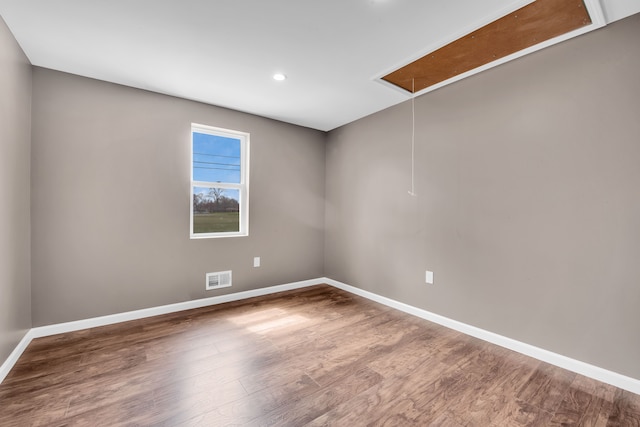 12751 Rosemary Blvd, Oak Park, MI 48237 - spare room with baseboards, recessed lighting, attic access, visible vents, and wood finished floors