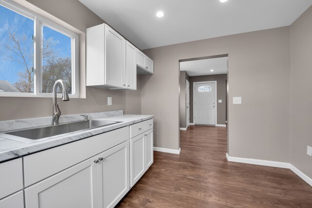 12751 Rosemary Blvd, Oak Park, MI 48237 - kitchen with baseboards, light countertops, white cabinets, dark wood-type flooring, and a sink