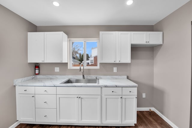12751 Rosemary Blvd, Oak Park, MI 48237 - kitchen with baseboards, recessed lighting, dark wood-style floors, white cabinets, and a sink