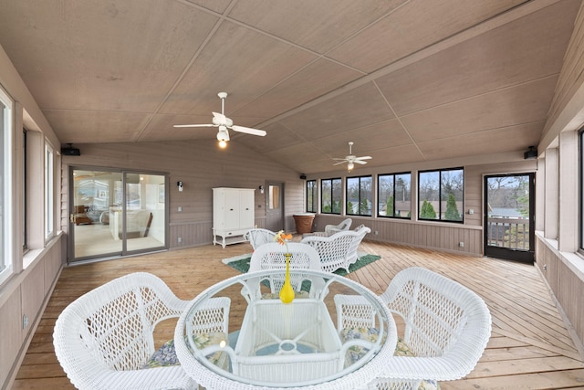 sunroom / solarium with a ceiling fan and outdoor dining area