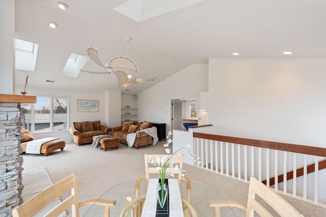 carpeted living area with vaulted ceiling with skylight, visible vents, and recessed lighting