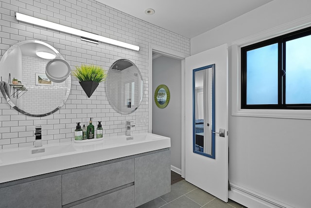 2370 Holtman Dr NE, Grand Rapids, MI 49525 - bathroom featuring a baseboard heating unit, tile patterned flooring, a sink, and baseboards