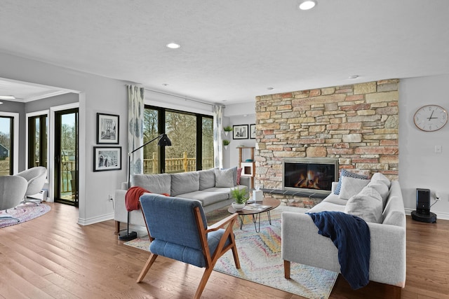 2370 Holtman Dr NE, Grand Rapids, MI 49525 - living area with baseboards, wood finished floors, a fireplace, and recessed lighting