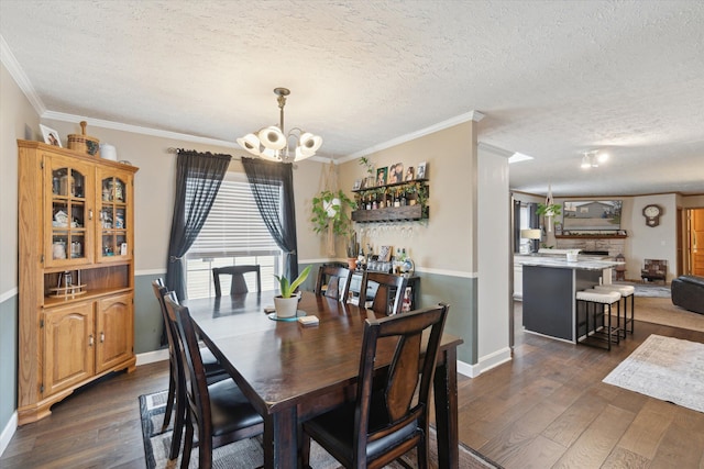 dining area with dark wood-type flooring, a chandelier, and a textured ceiling