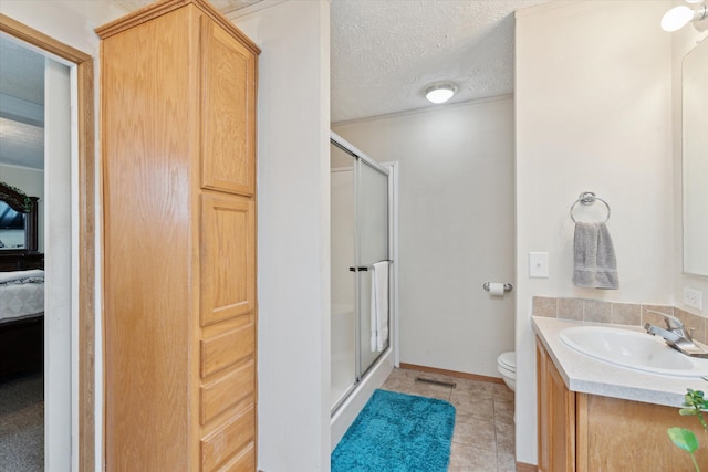 ensuite bathroom featuring tile patterned floors, toilet, a shower stall, and visible vents