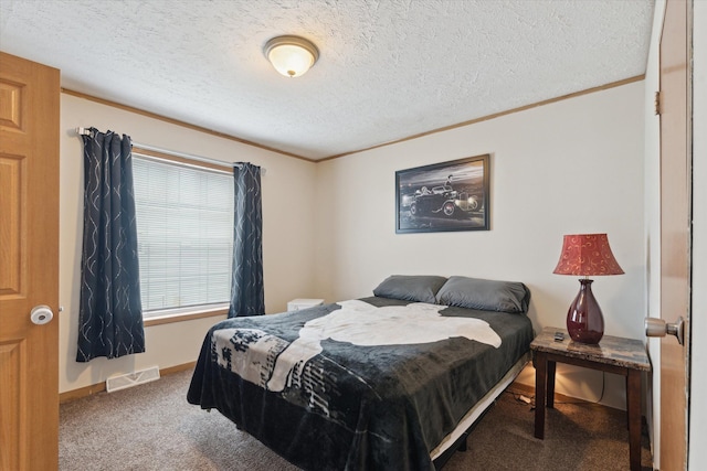 bedroom with ornamental molding, visible vents, carpet flooring, and a textured ceiling