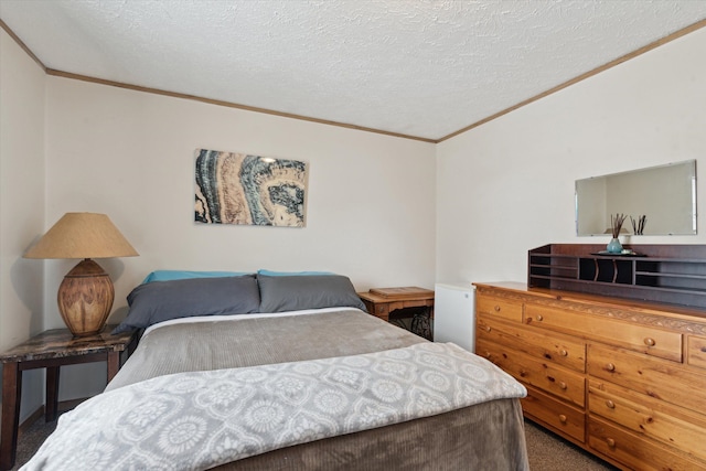 bedroom featuring ornamental molding, carpet flooring, and a textured ceiling