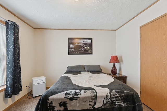 bedroom featuring ornamental molding, carpet flooring, and a textured ceiling