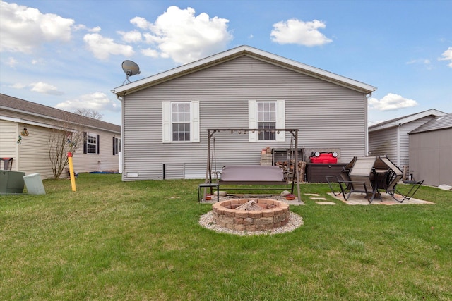rear view of house featuring an outdoor fire pit, a patio, and a lawn