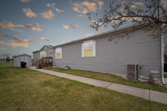 view of side of property with an outdoor structure and a lawn