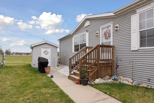 view of exterior entry featuring a lawn